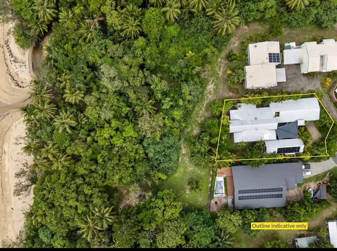 Aerial view of the house among the rainforest, steps from the beach