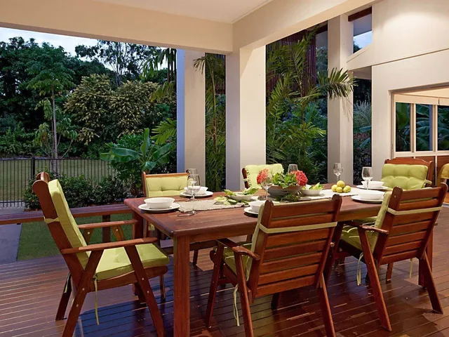 Covered deck set for dinner beside the garden