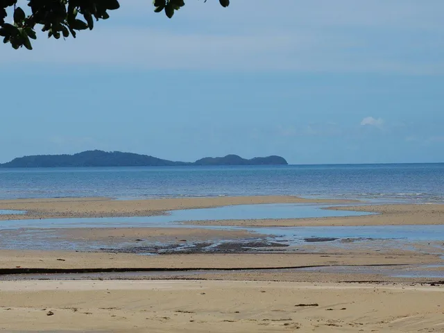 Calm water at low tide looking out to the islands