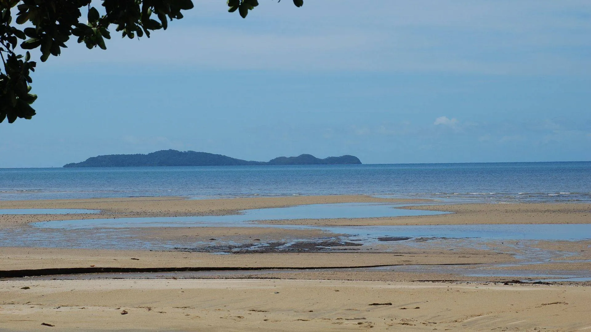 Calm water at low tide looking out to the islands