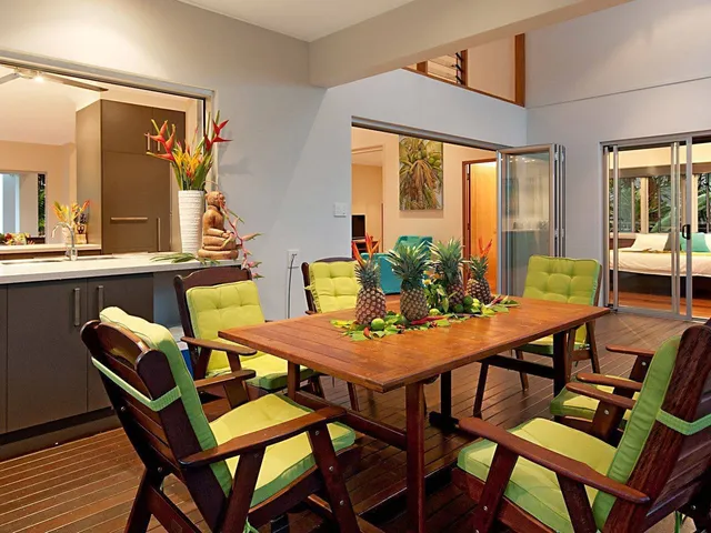 Dining table set with tropical flowers and fruit