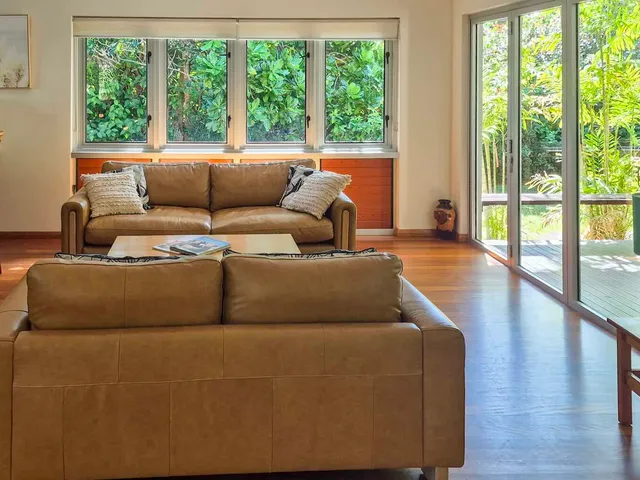 Open-plan lounge and breakfast bar with bi-fold doors to the garden