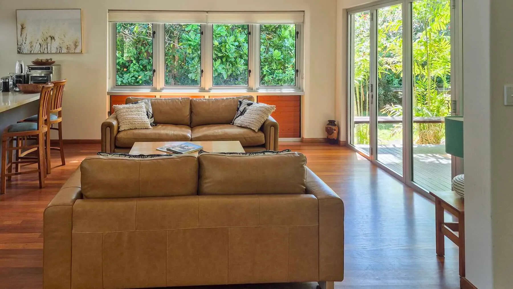 Open-plan lounge and breakfast bar with bi-fold doors to the garden