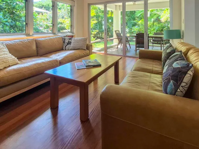 Living room with leather lounges opening onto the garden