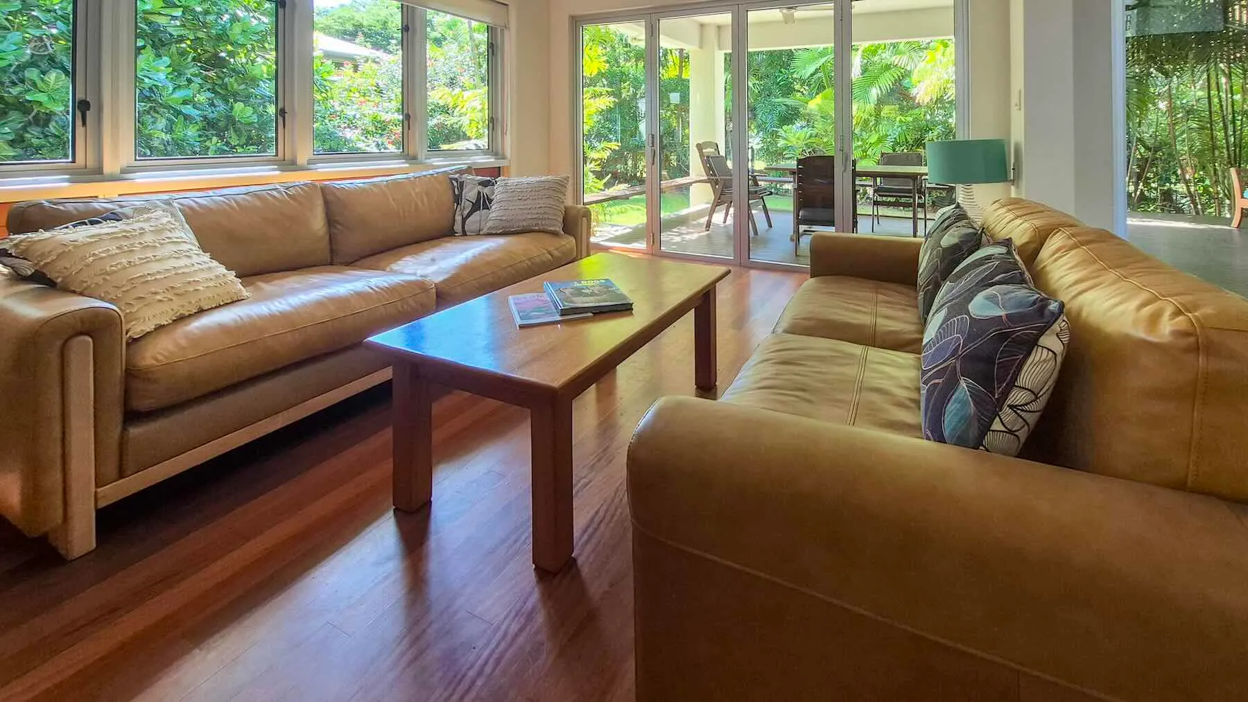Living room with leather lounges opening onto the garden deck