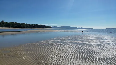 Sand ripples and calm water at low tide