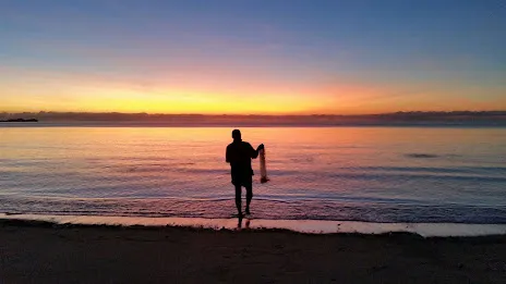 Throwing a cast net at dawn