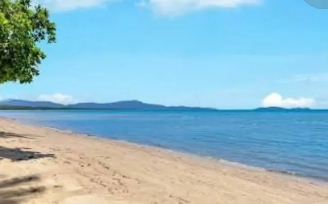 Wide sandy beach under a blue sky